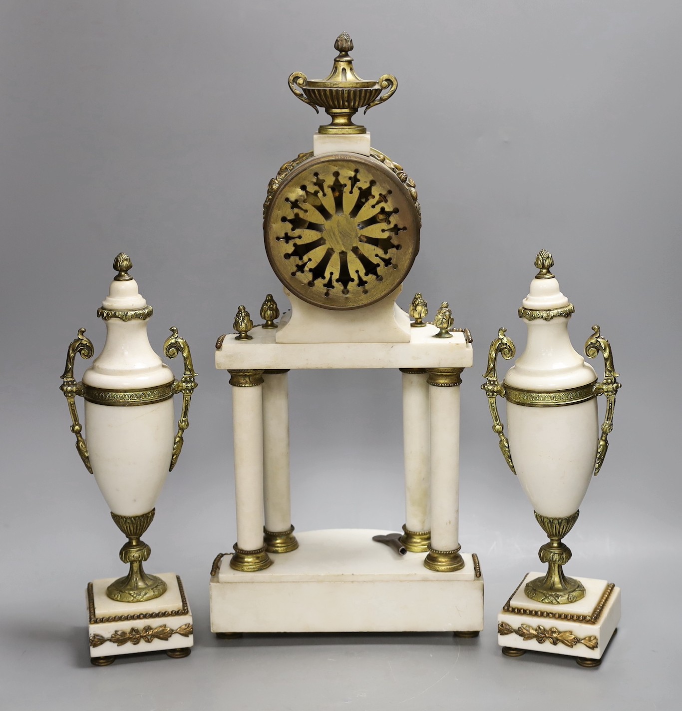 A Louis XVI style white marble and ormolu clock garniture, clock 47cms high